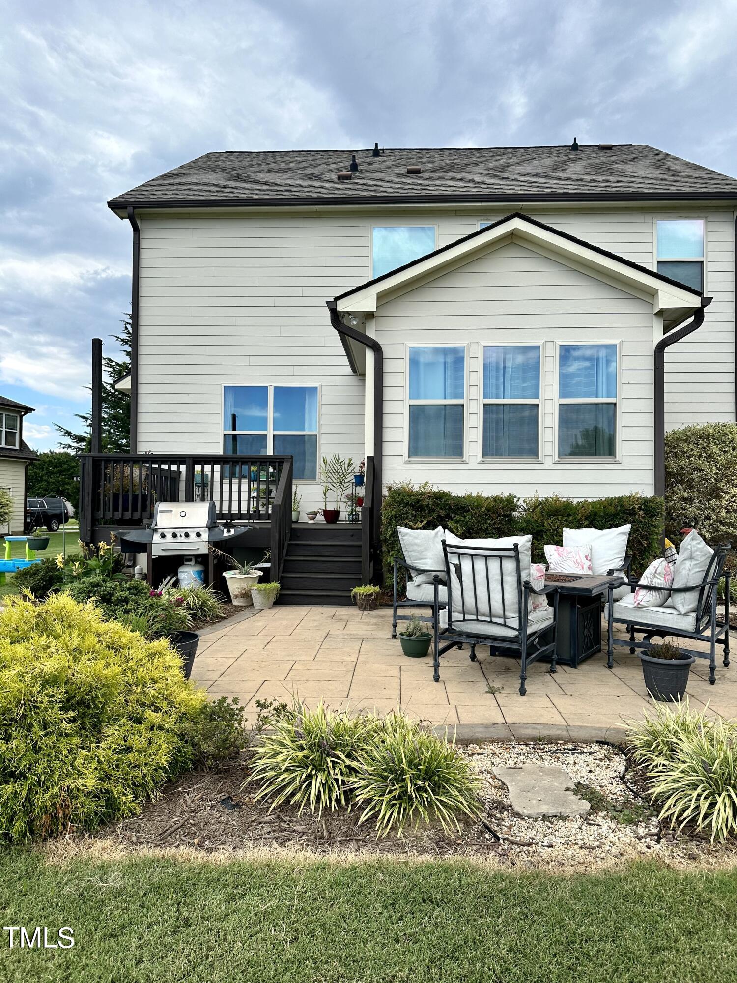 8305 Pin Cherry Drive Willow Spring, NC 27592 - Photo 52 of 60 a front view of a house with a yard outdoor seating and mountain view