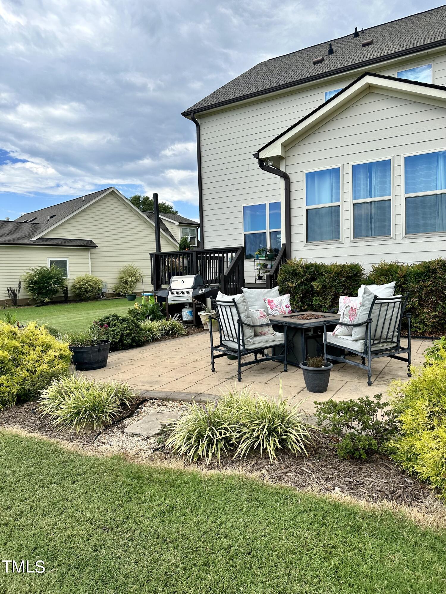 8305 Pin Cherry Drive Willow Spring, NC 27592 - Photo 54 of 60 a swimming pool with outdoor seating and garden