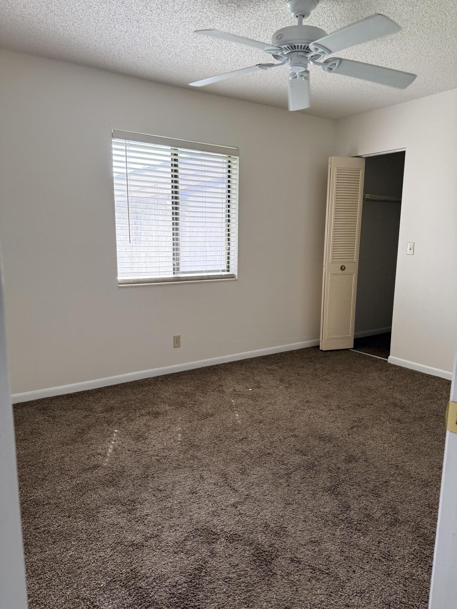 520 Shady Pine Way, Unit C2 Greenacres, FL 33415 - Photo 5 of 10 a view of an empty room with a window