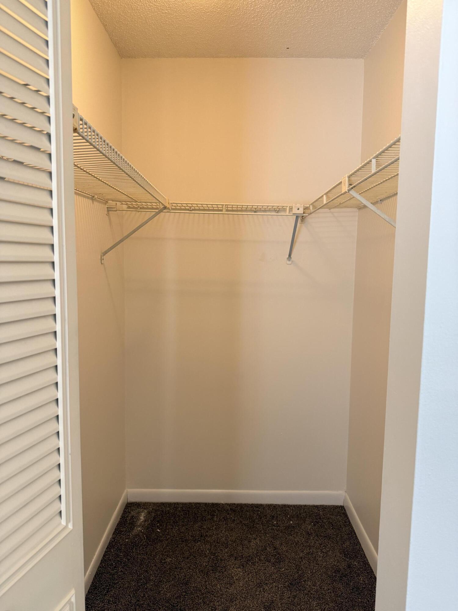 520 Shady Pine Way, Unit C2 Greenacres, FL 33415 - Photo 6 of 10 a view of small space with racks on the wall