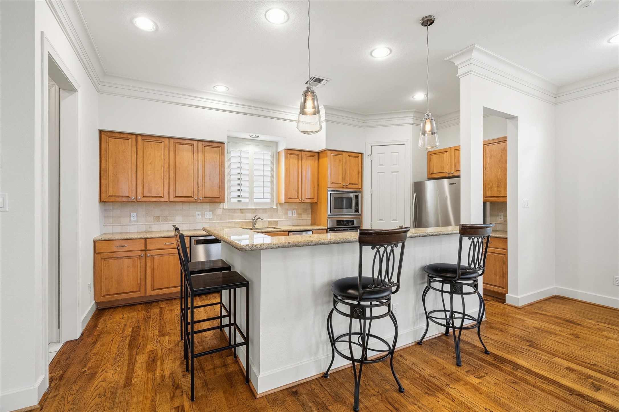 5507 Val Verde Street Houston, TX 77056 - Photo 22 of 42 a kitchen with sink cabinets and wooden floor