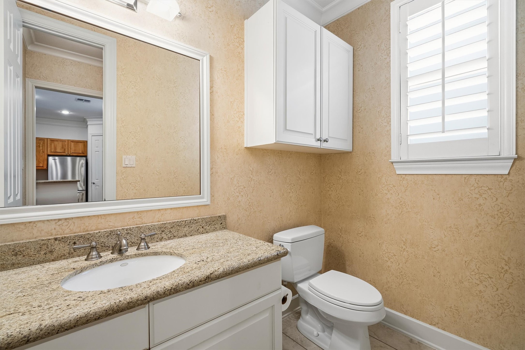 5507 Val Verde Street Houston, TX 77056 - Photo 28 of 42 a bathroom with a granite countertop toilet a sink and a mirror