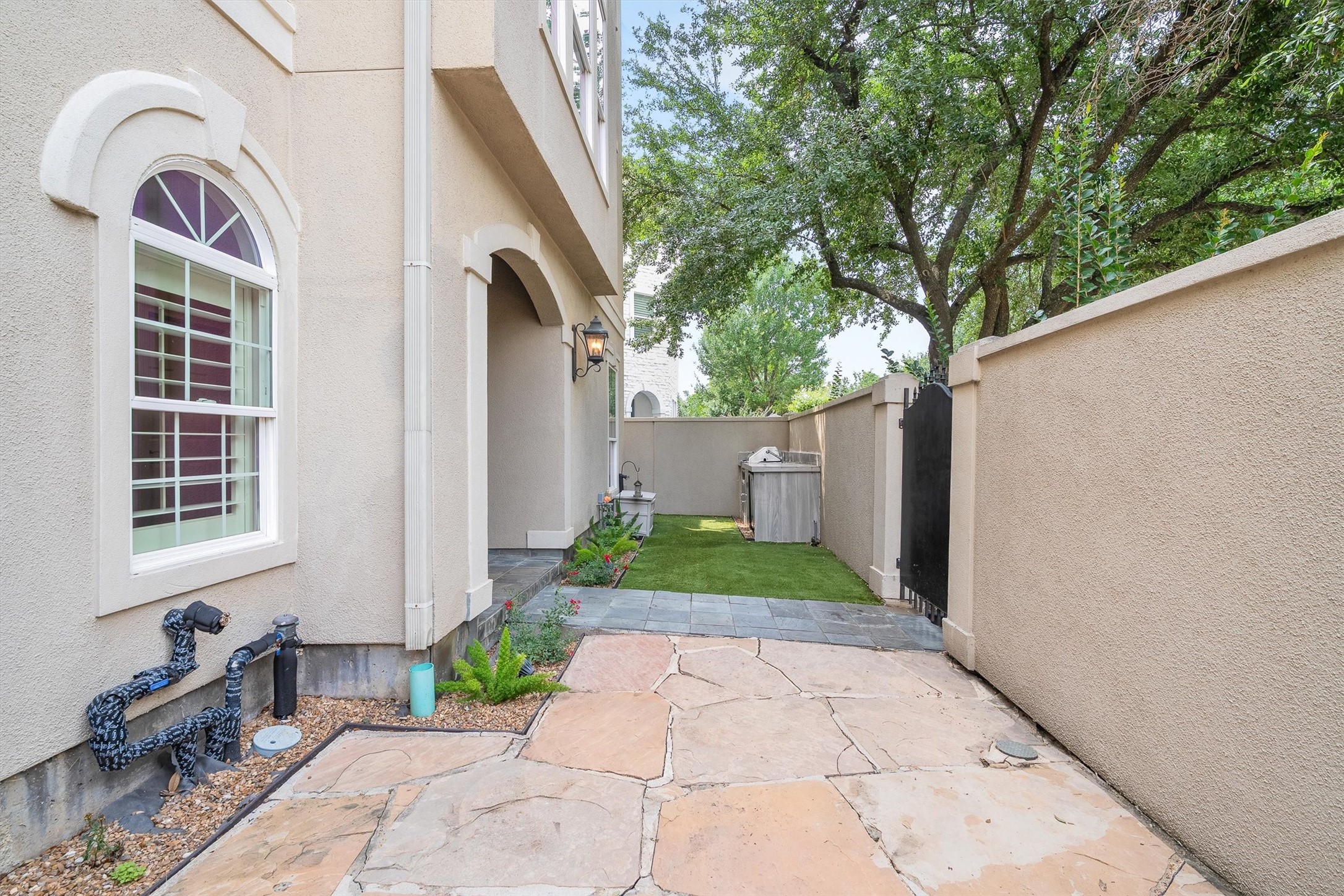5507 Val Verde Street Houston, TX 77056 - Photo 7 of 42 Fully-Enclosed gated area in front that houses the outdoor kitchen to your right as you walk up the sidewalk and a lovely stone patio to your left of the entry-way sidewalk