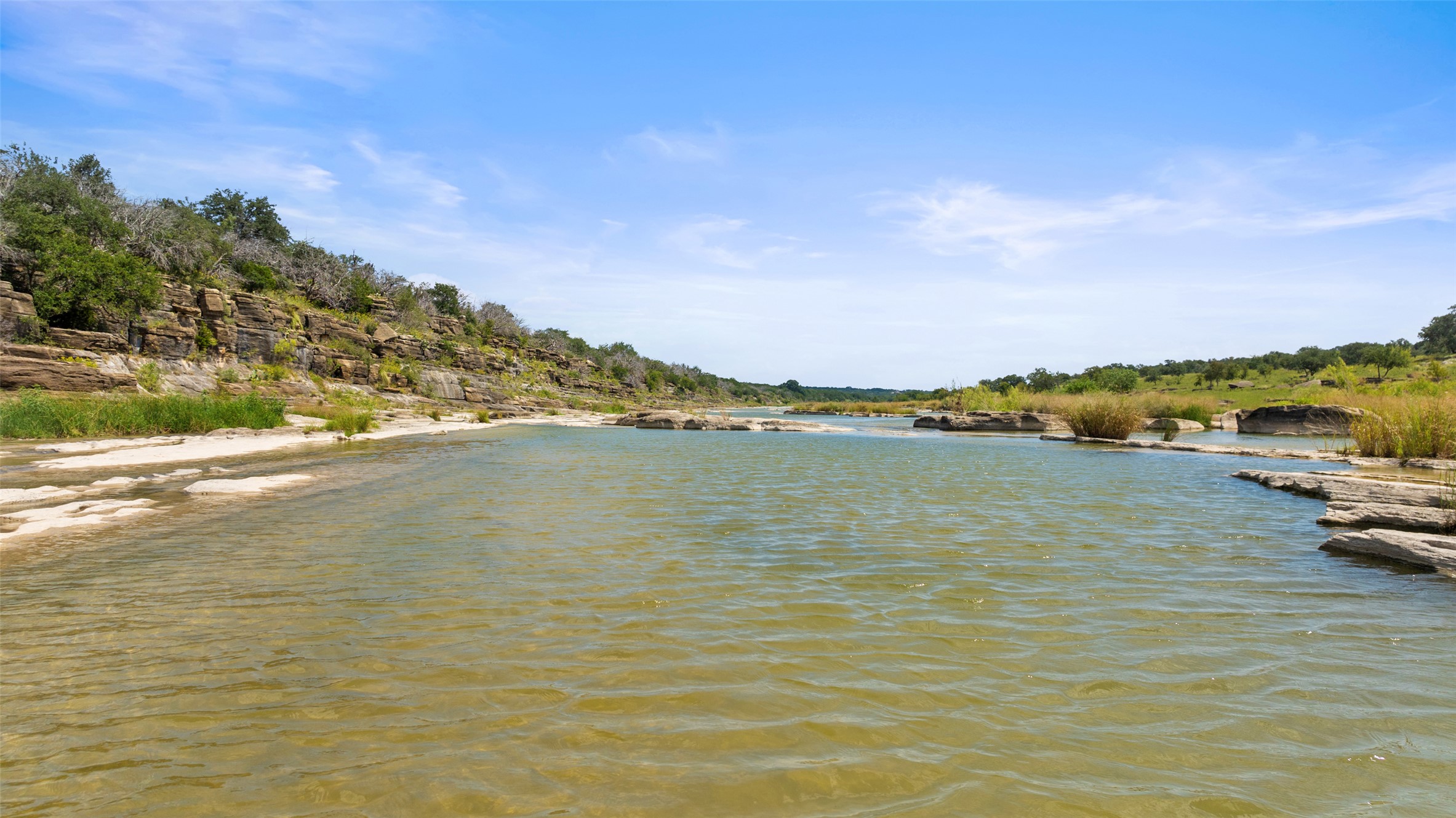 960 Gibson Road Johnson City, TX 78636 - Photo 18 of 19 Natural rock formations frame the crystal-clear waters of this scenic riverside property.