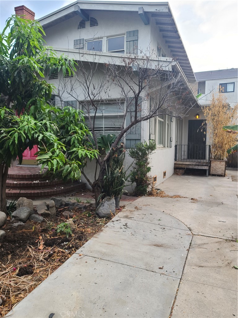 1148 Locust Avenue Long Beach, CA 90813 - Photo 1 of 22 a front view of a house with a garden