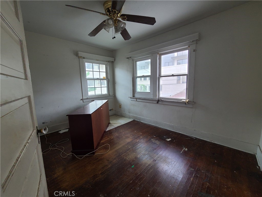 1148 Locust Avenue Long Beach, CA 90813 - Photo 13 of 22 a view of an empty room with a window and wooden floor