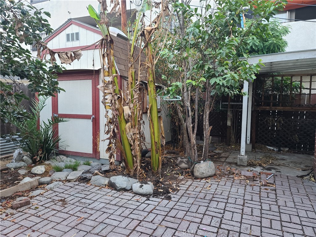 1148 Locust Avenue Long Beach, CA 90813 - Photo 16 of 22 a view of a house with a backyard and a tree