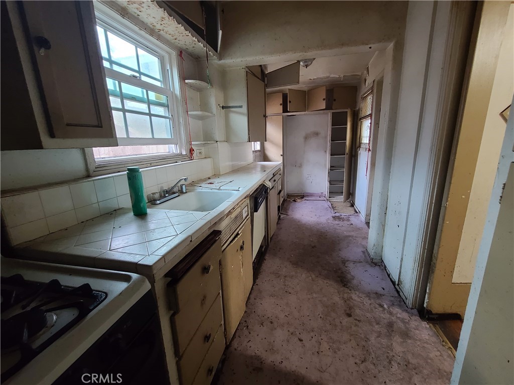 1148 Locust Avenue Long Beach, CA 90813 - Photo 8 of 22 a kitchen with granite countertop a sink stove and refrigerator