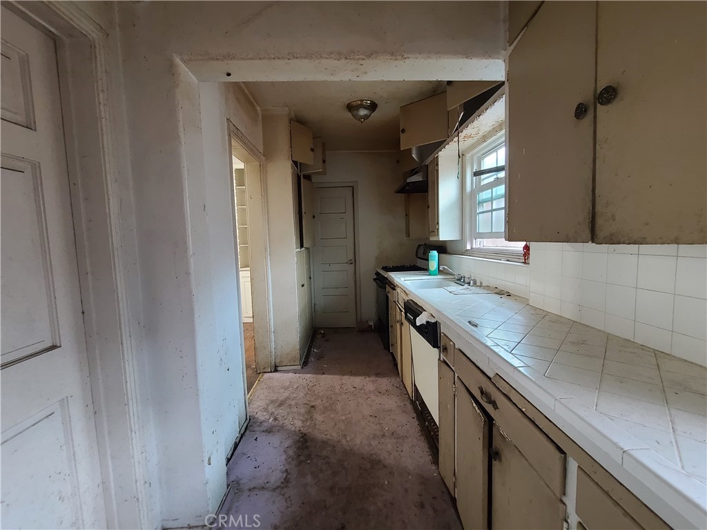 1148 Locust Avenue Long Beach, CA 90813 - Photo 9 of 22 a kitchen with a sink stove and cabinets