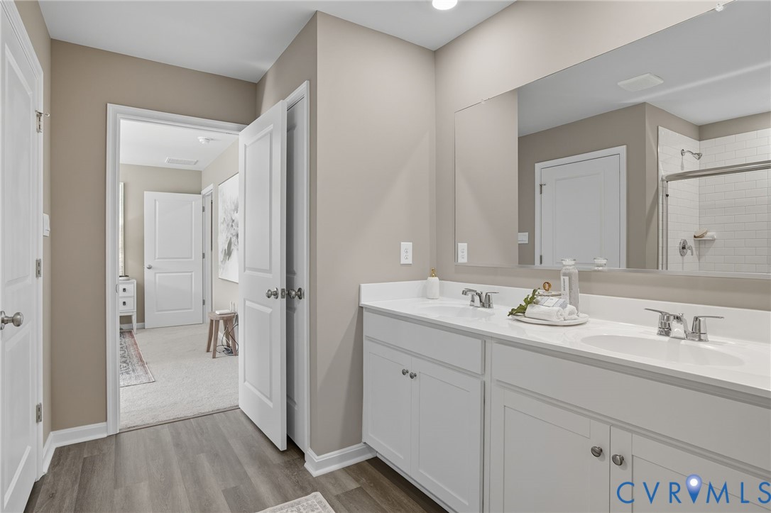 7707 Arbor Marsh Terrace New Kent, VA 23124 - Photo 17 of 27 a en suite bathroom with a sink mirror and shower