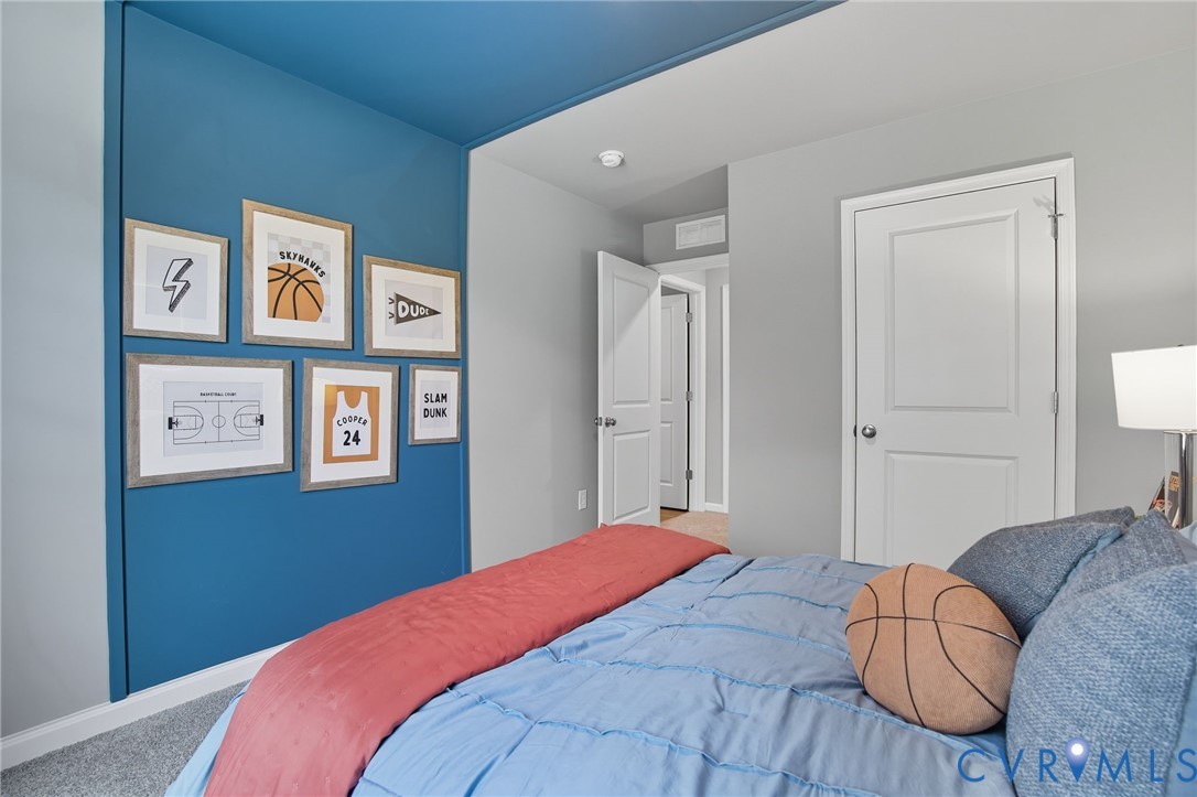 7707 Arbor Marsh Terrace New Kent, VA 23124 - Photo 18 of 27 a bedroom with a bed and painting on the wall