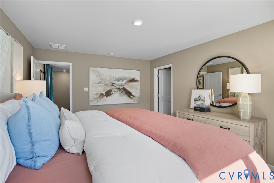 7707 Arbor Marsh Terrace New Kent, VA 23124 - Photo 23 of 27 a bedroom with a bed and glass windows