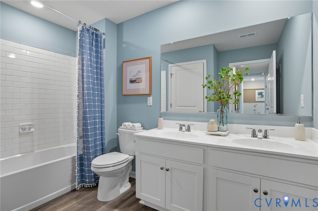 7707 Arbor Marsh Terrace New Kent, VA 23124 - Photo 25 of 27 a bathroom with a toilet sink and mirror