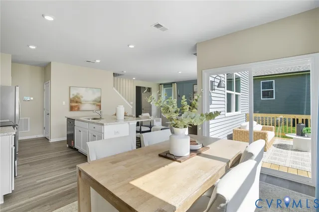 a view of a dining room with furniture and wooden floor