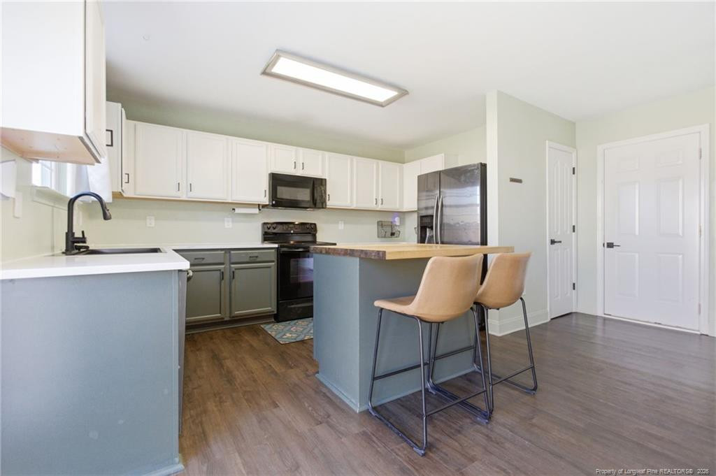 334 Crane Way Bunnlevel, NC 28323 - Photo 14 of 45 a kitchen with a sink cabinets and wooden floor