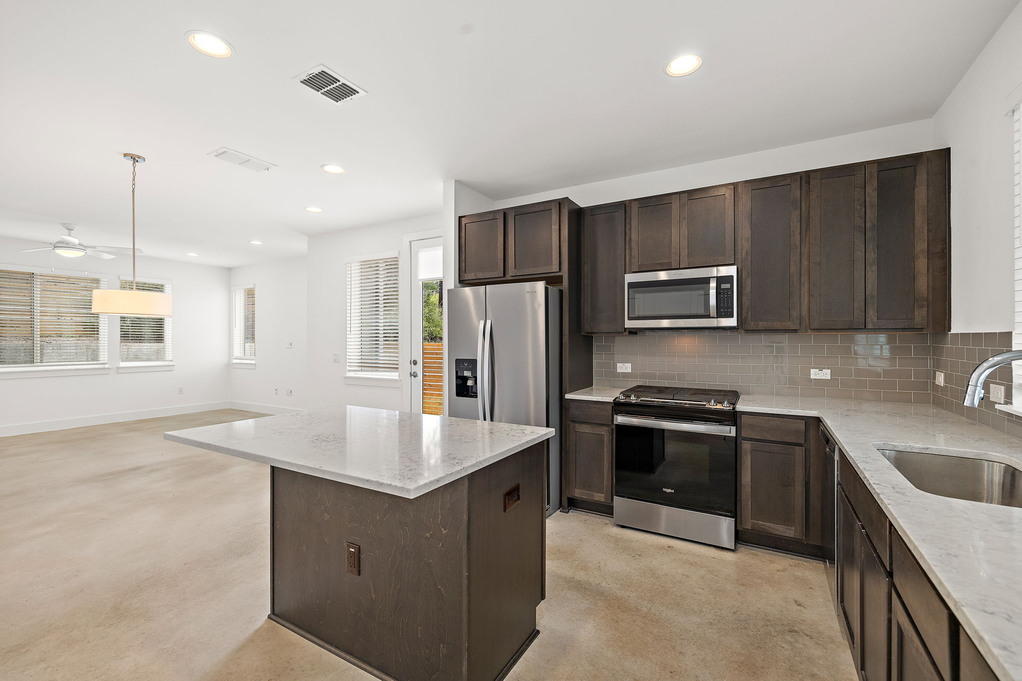 1206 Sarabeth Way Austin, TX 78721 - Photo 14 of 27 Kitchen featuring visible vents, appliances with stainless steel finishes, decorative backsplash, and a sink