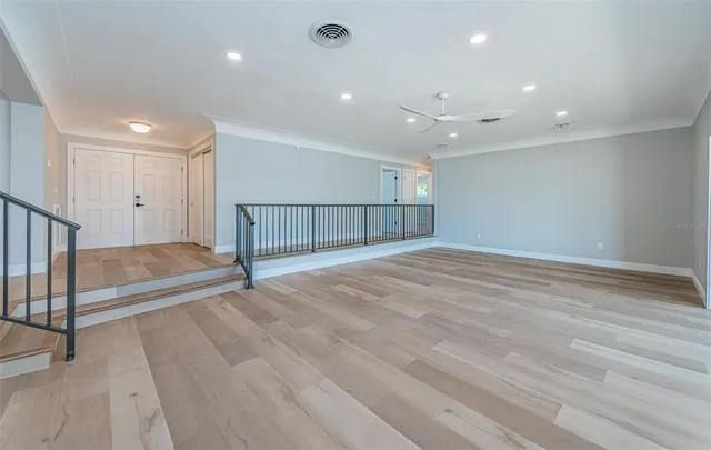 a large kitchen with cabinets stainless steel appliances and a counter space