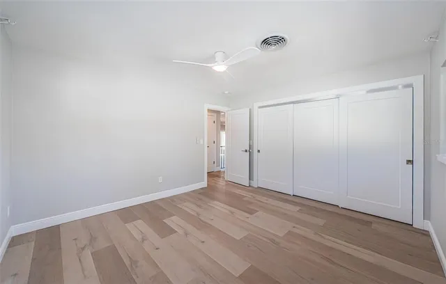 a view of a house with wooden deck and furniture