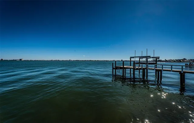 a large body of water with a table and chairs