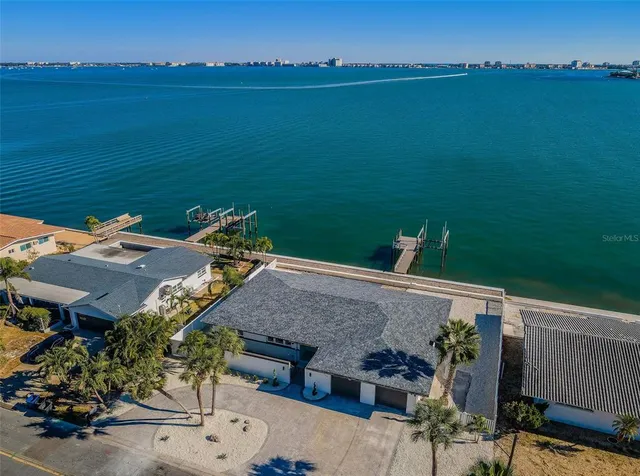 an aerial view of a house with a lake view
