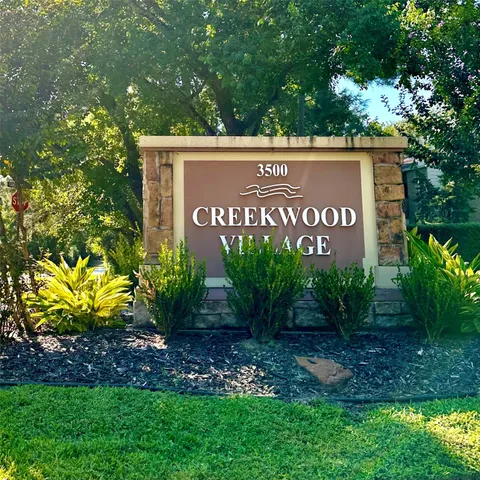 a sign that is sitting in front of flowers