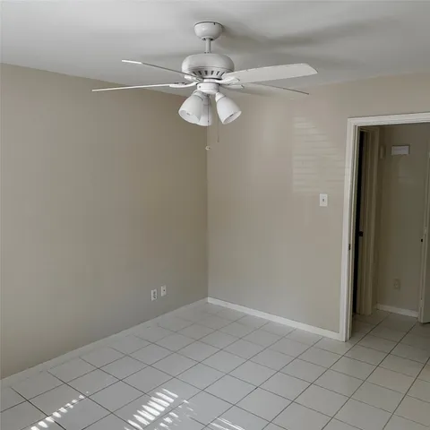 a view of a small space with a chandelier fan