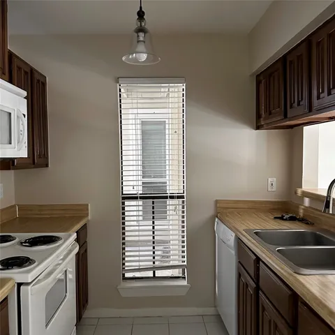 a kitchen that has a sink and a stove