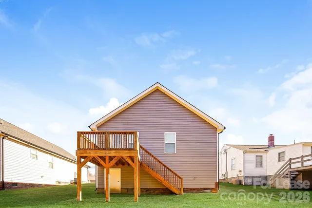 a view of a house with wooden fence