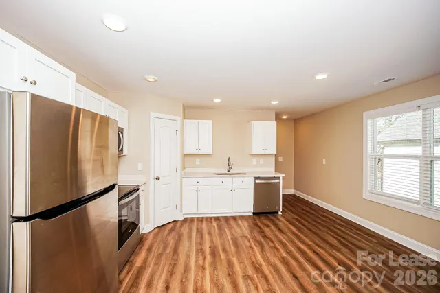 a kitchen with a refrigerator and a sink