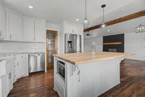 a kitchen with stainless steel appliances granite countertop a stove and a refrigerator