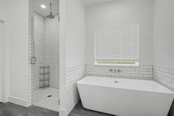 a bathroom with a bathtub and shower