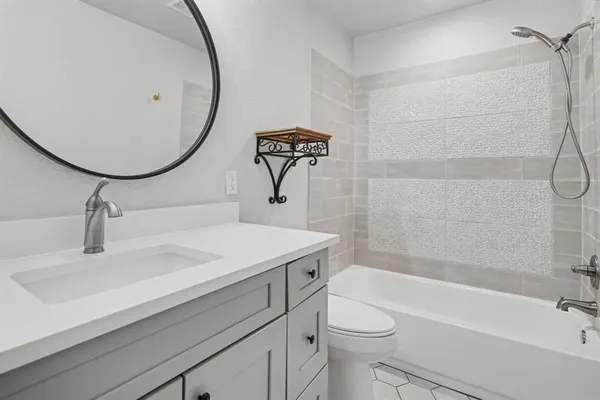 a bathroom with a sink a toilet and bathtub