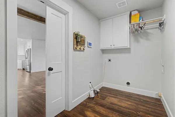 a view of a room with wooden floor and bathroom