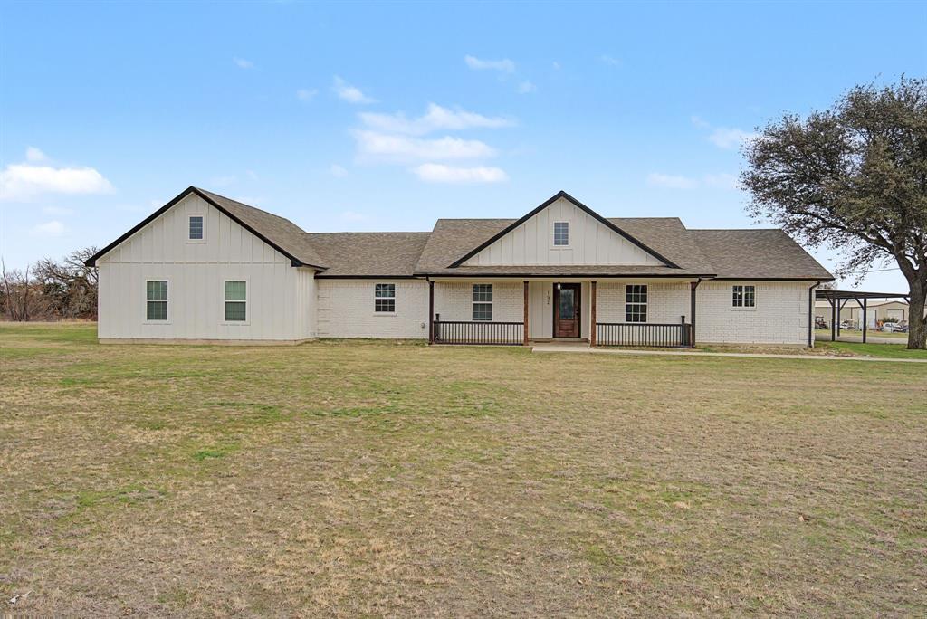 192 Riverside Drive Decatur, TX 76234 - Photo 3 of 32 a front view of a house with a garden