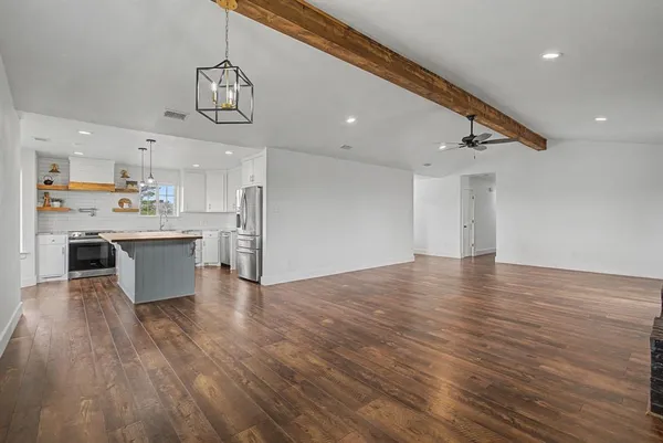 a view of a kitchen with a sink stainless steel appliances and cabinets