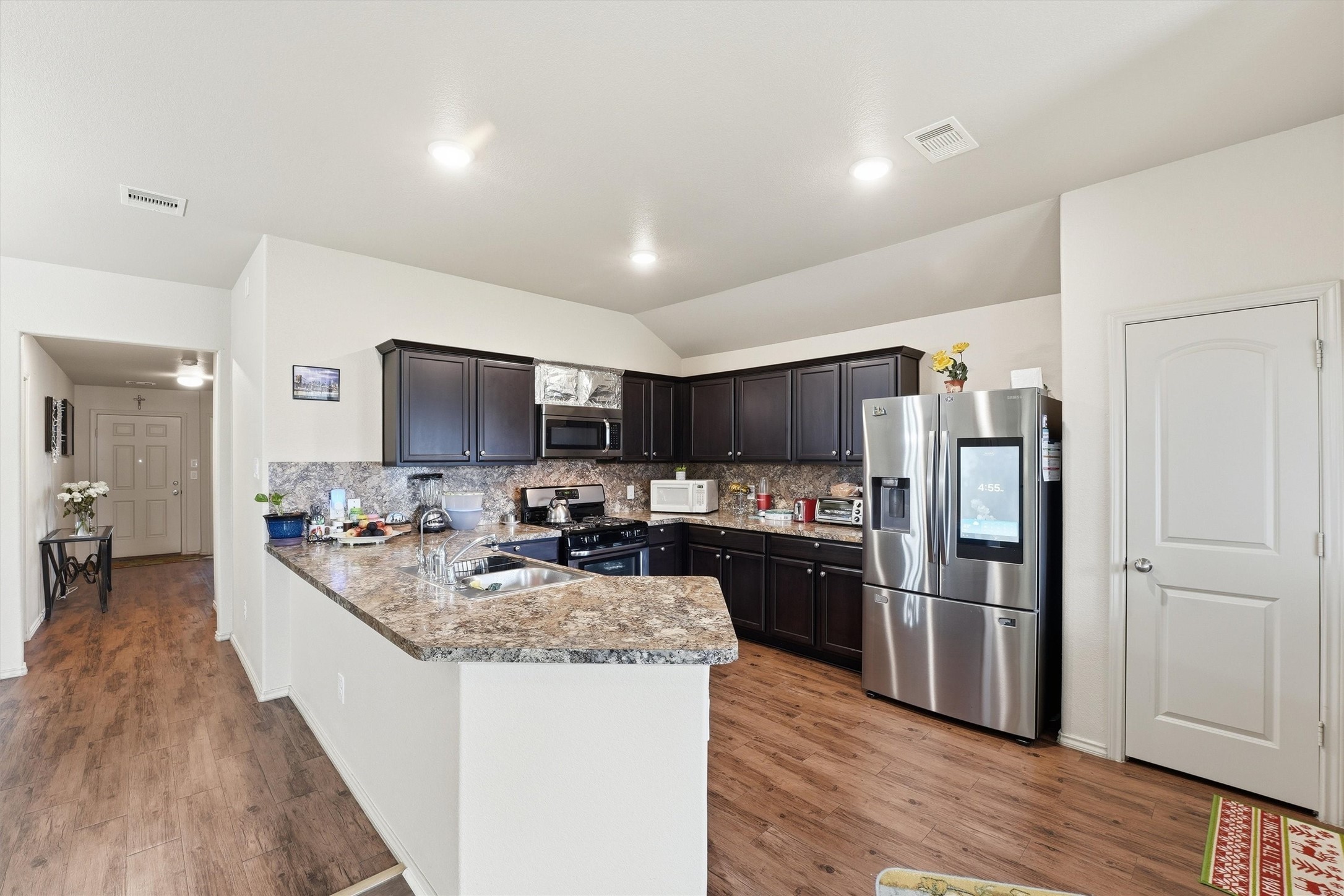 15455 Rancho Joya Way Houston, TX 77049 - Photo 5 of 20 a large kitchen with a center island and stainless steel appliances