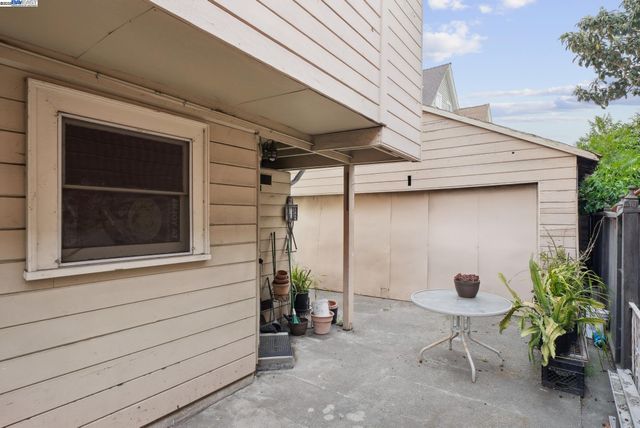 a backyard of a house with potted plants
