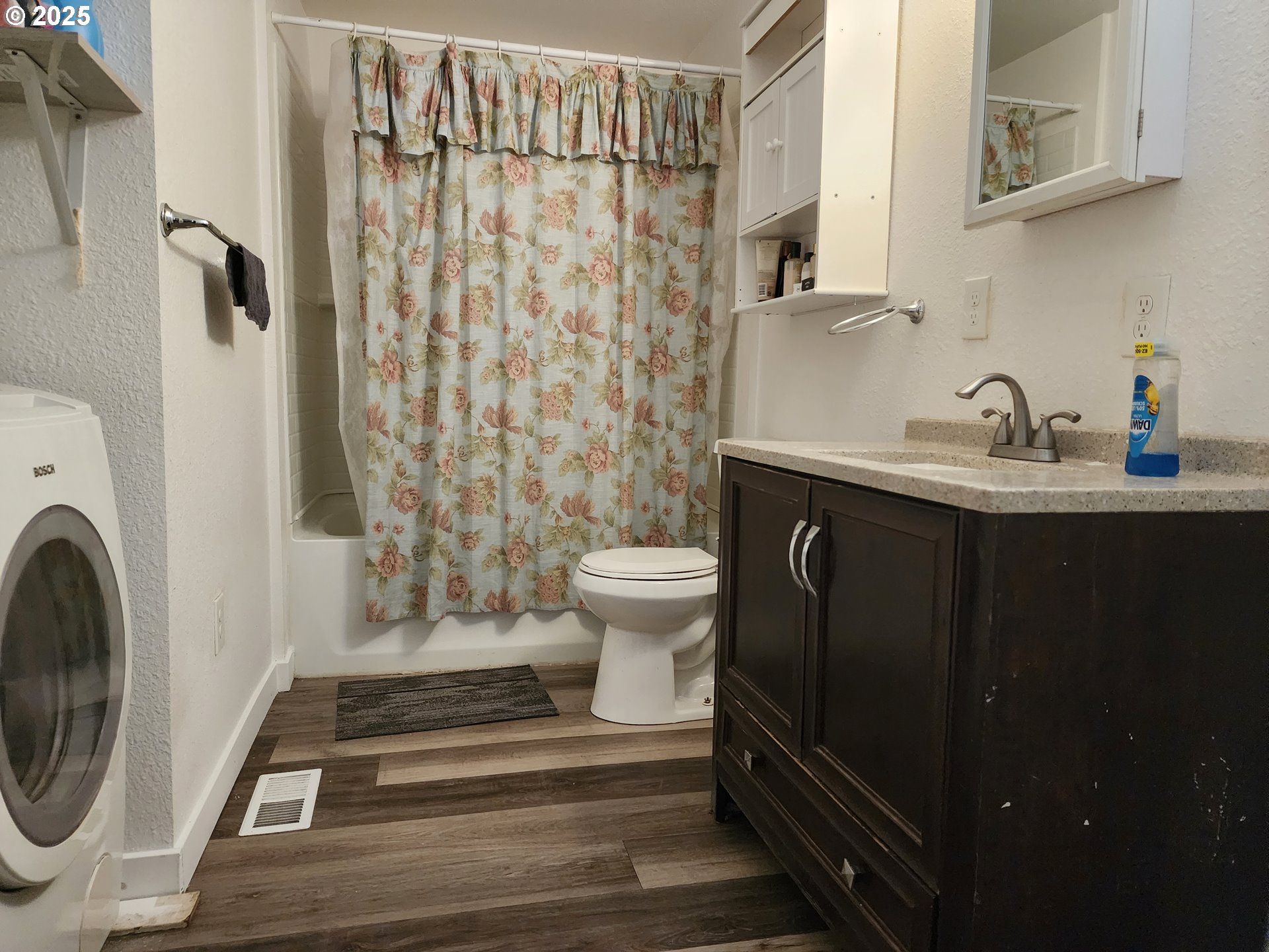 4061 Hawthorne Avenue Northeast Salem, OR 97301 - Photo 10 of 13 a bathroom with a sink a toilet and shower curtain