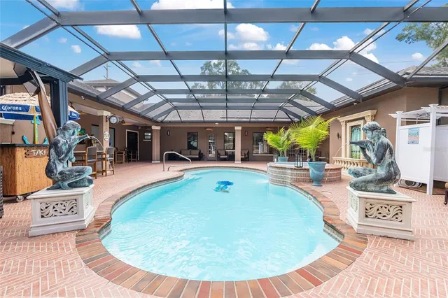 a kitchen with stainless steel appliances granite countertop a sink a stove a refrigerator cabinets and living room view