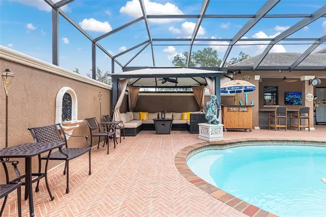 a view of a dining room with furniture and chandelier