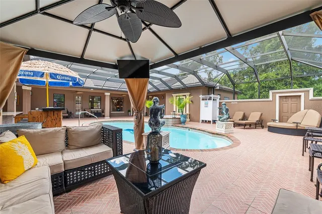 a dining room with furniture a chandelier and window