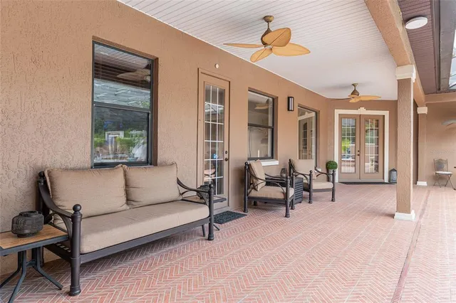 a view of a hallway with a flat screen tv and kitchen view
