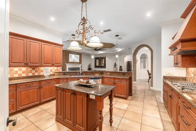 a kitchen with stainless steel appliances granite countertop a sink and a stove