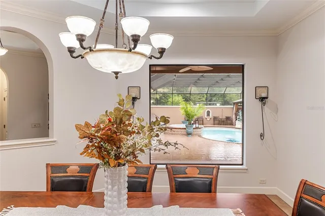 a view of a patio with a table chairs and a ocean view