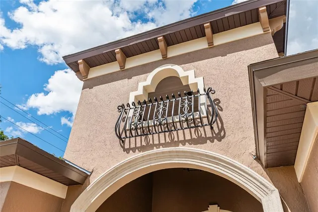 a view of a house with backyard sitting area and furniture