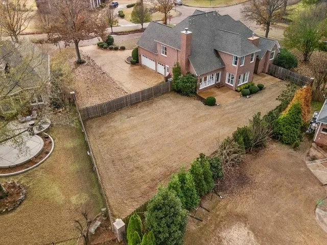 an aerial view of a house with yard and garage