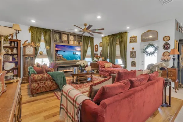 a living room with furniture fireplace and a window