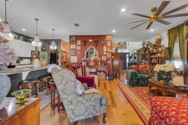 a living room filled with furniture and a chandelier