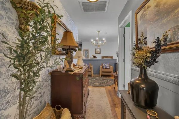 a living room with furniture and a chandelier