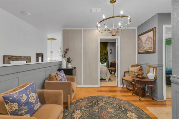 a living room with furniture and a chandelier